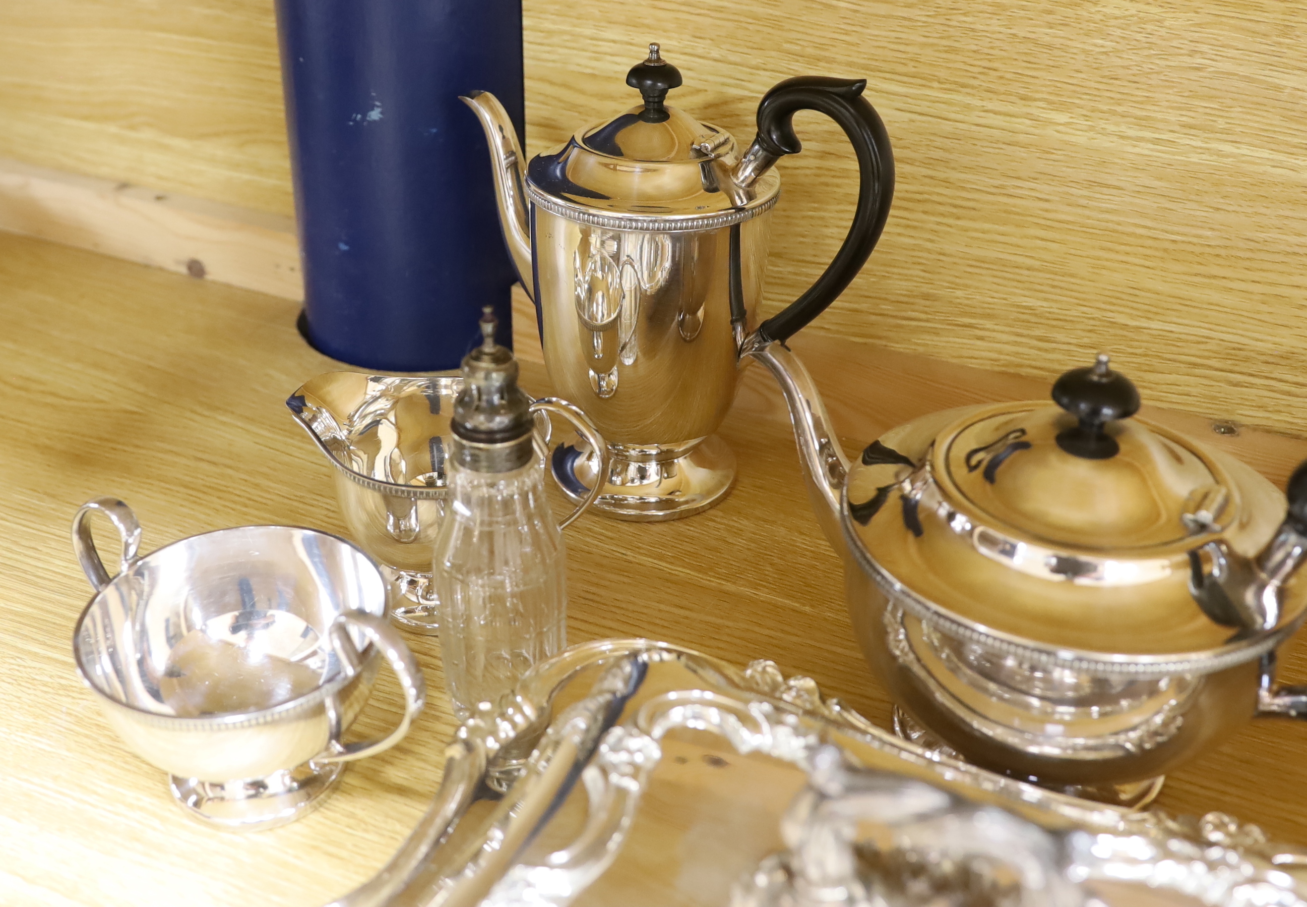 A quantity of silver plate including tea and coffee pots with ebonised handles and a pair of serving dishes